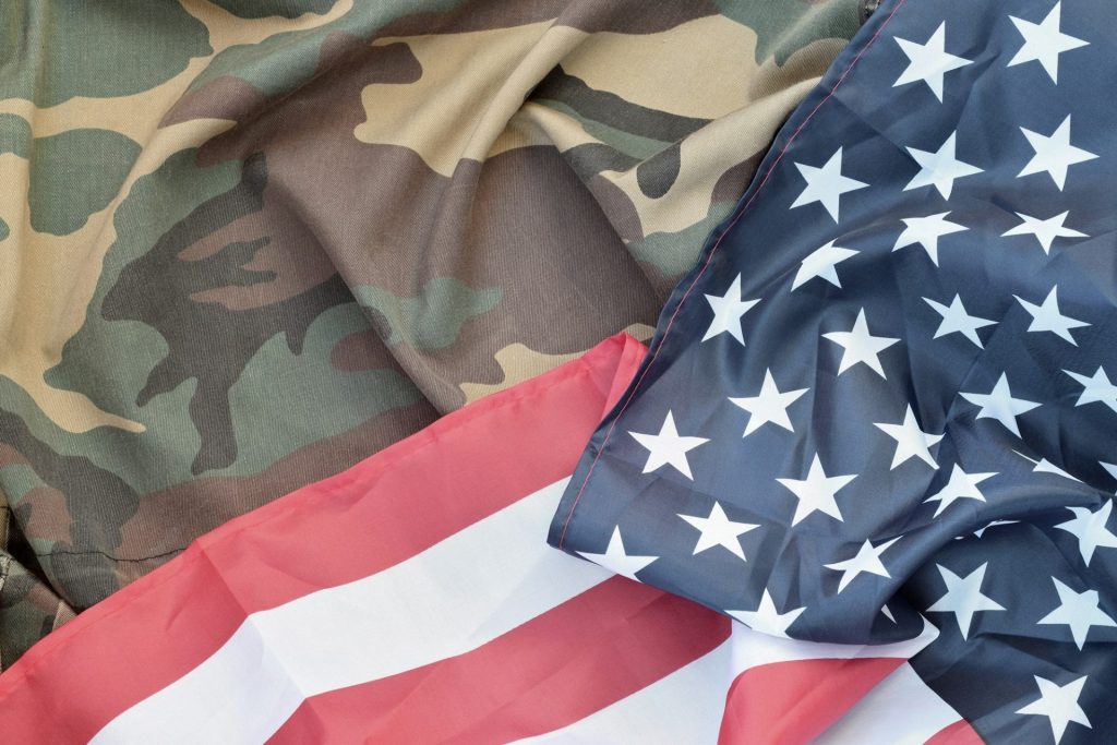 United States of America flag and folded military uniform jacket